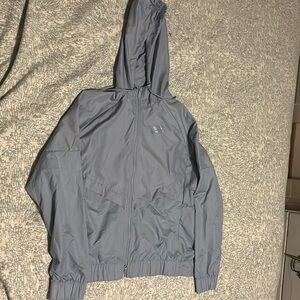 A gray Nike rain jacket size large in kids never worn.